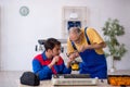 Two male repairmen repairing air-conditioner