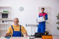 Two male repairmen working at workshop Royalty Free Stock Photo
