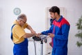 Two male repairmen working at workshop Royalty Free Stock Photo