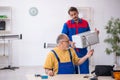 Two male repairmen working at workshop