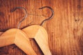 Two retro cloth hangers on rustic wooden background, top view Royalty Free Stock Photo