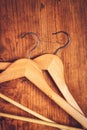 Two retro cloth hangers on rustic wooden background, top view