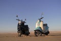 Two Retro scooters at sunset in the golden sand of the Namib Desert Royalty Free Stock Photo