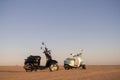 Two scooters at sunset in the golden sand of the Namib Desert Royalty Free Stock Photo