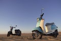 Two scooters at sunset in the golden sand of the Namib Desert Royalty Free Stock Photo