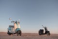 Two Retro scooters at sunset in the sand of the Namib Desert Royalty Free Stock Photo