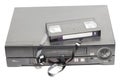 Retro video cassette recorder with broken VHS cassette with unwound tape