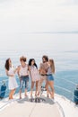 Yacht party with young people having a boat party, dancing on a bow of yacht deck Royalty Free Stock Photo