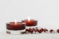 Two rich red candle holder votive and pearls Royalty Free Stock Photo