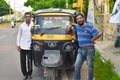 Two rickshaw driver smile with their auto