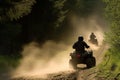 two riders on atvs racing alongside a forest trail, dust trail behind Royalty Free Stock Photo