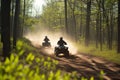 two riders on atvs racing alongside a forest trail, dust trail behind Royalty Free Stock Photo