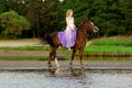 Two riders on horseback at sunset on the beach. Lovers ride horseback. Young beautiful man and woman with a horse at the sea. Rom