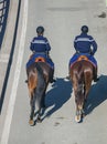 Two riders in uniform with the inscription GENDARMERIE on the back move around the city on horseback