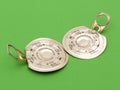 Two ring-pull metal lids on green