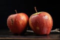 two ripe apples with visible bite marks on them