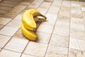 Two ripe bananas on a checkered wooden surface