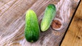 Two ripe green cucumbers are lying on a wooden Board. Vegetables close-up Royalty Free Stock Photo