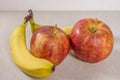 Two Apples and Bananas Isolated on a Gray White Grey Marble Slate Background Royalty Free Stock Photo