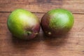 Two ripe mangoes on a wooden background Royalty Free Stock Photo