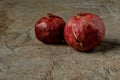 Two ripe pomegranates on rustic backgrounds