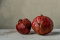 Two ripe pomegranates on rustic backgrounds