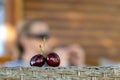 Two ripe red cherries on a defocused background, close-up, the concept of a romantic relationship Royalty Free Stock Photo