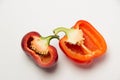 Two ripe red peppers in a cut on a white background Royalty Free Stock Photo