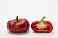 Two ripe red peppers in a cut on a white background Royalty Free Stock Photo