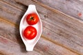 Two ripe red tomatoes in a dish Royalty Free Stock Photo