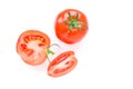 Two ripe red tomatoes are on the white background. One is cut in slices. Royalty Free Stock Photo