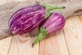 Two graffiti eggplants on the rustic table close-up Royalty Free Stock Photo