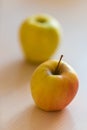 Two ripe yellow orange apple on the table Royalty Free Stock Photo