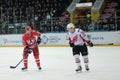 Two rival hockey player smiling at each other