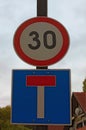 Two road signs on post against cloudy sky represent speed limit and deadlock sign. Balatonfoldvar, Hungary. Concept of road sign Royalty Free Stock Photo