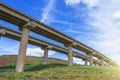 Two road turn highway bridge, viaduct supports in the valley among the green hills, transport infrastructure