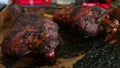 Two roasted mutton lamb leg covered with baking paper on baking tray