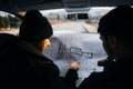 Two robbers planning and pointing on the blueprint map