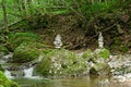 Two rock stacks in a streambed, piles of stacked rocks