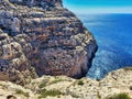 Two rocks kissing on a sunny day on blue sky and sea background. Sea water and rocks. A little tree grows on high mountain. Ocean Royalty Free Stock Photo