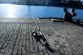 two rods on concrete next to water and city buildings, Royalty Free Stock Photo