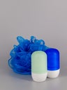 Two roll-on deodorants with a scrub nylon sponge - Bath products Royalty Free Stock Photo