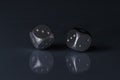 Two Rolling Silver Casino Dice on Black Background with blue bottom Royalty Free Stock Photo