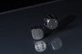 Two Rolling Steel Silver Casino Dice on Black Background with blue bottom Royalty Free Stock Photo