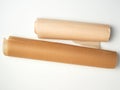 two rolls of brown parchment paper for baking on a white background Royalty Free Stock Photo