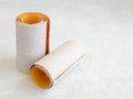 Two rolls of extra coarse and super fine aluminum oxide sandpaper on a white rough textured background. Abrasive paper for dry Royalty Free Stock Photo