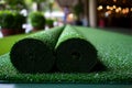 Two rolls of green artificial turf are displayed indoors Royalty Free Stock Photo