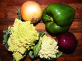 Two Romanescu cabbage, yellow onion, purple onion, green bell pepper