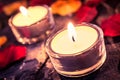 Two Romantic Candles On Slate With Rose Petals And Leafs