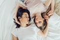 Two romantic girls looking at each other while having a rest on the bed